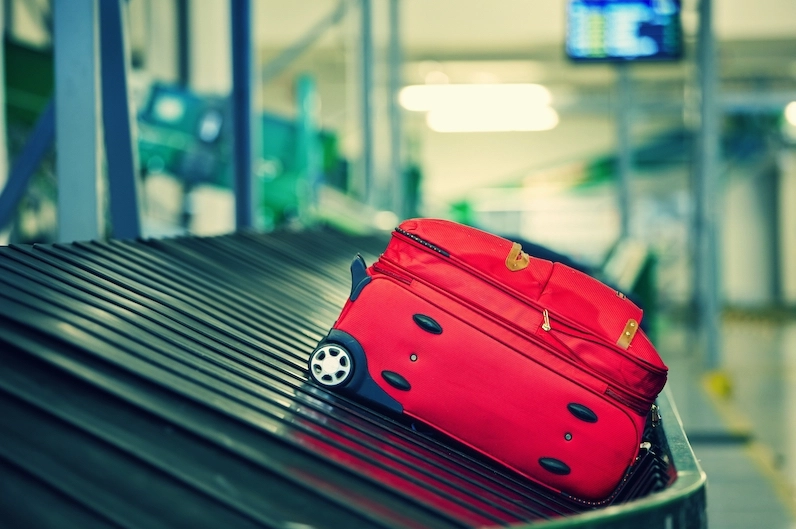 Hành khách kéo vali hành lý ký gửi tại sân bay để bay với Vietjet